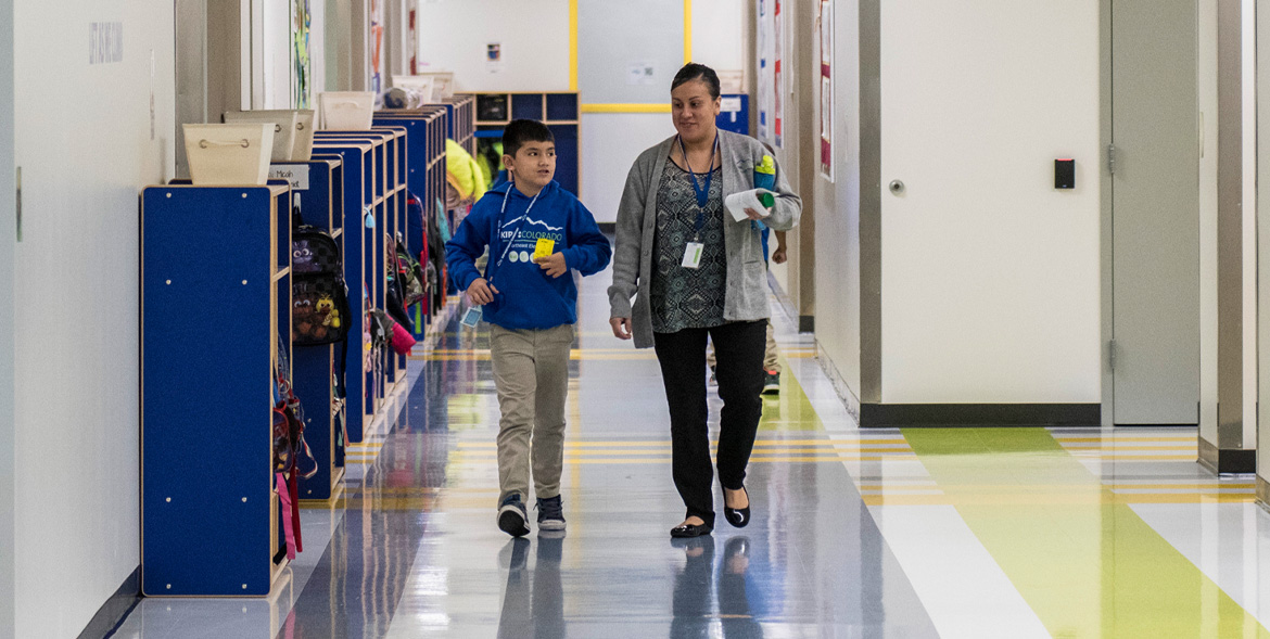 Photo of student and teacher walking in the hall